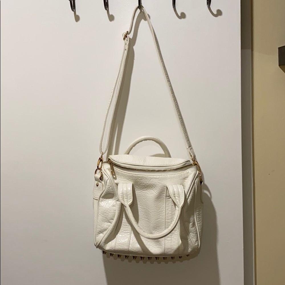 white and gold studded purse